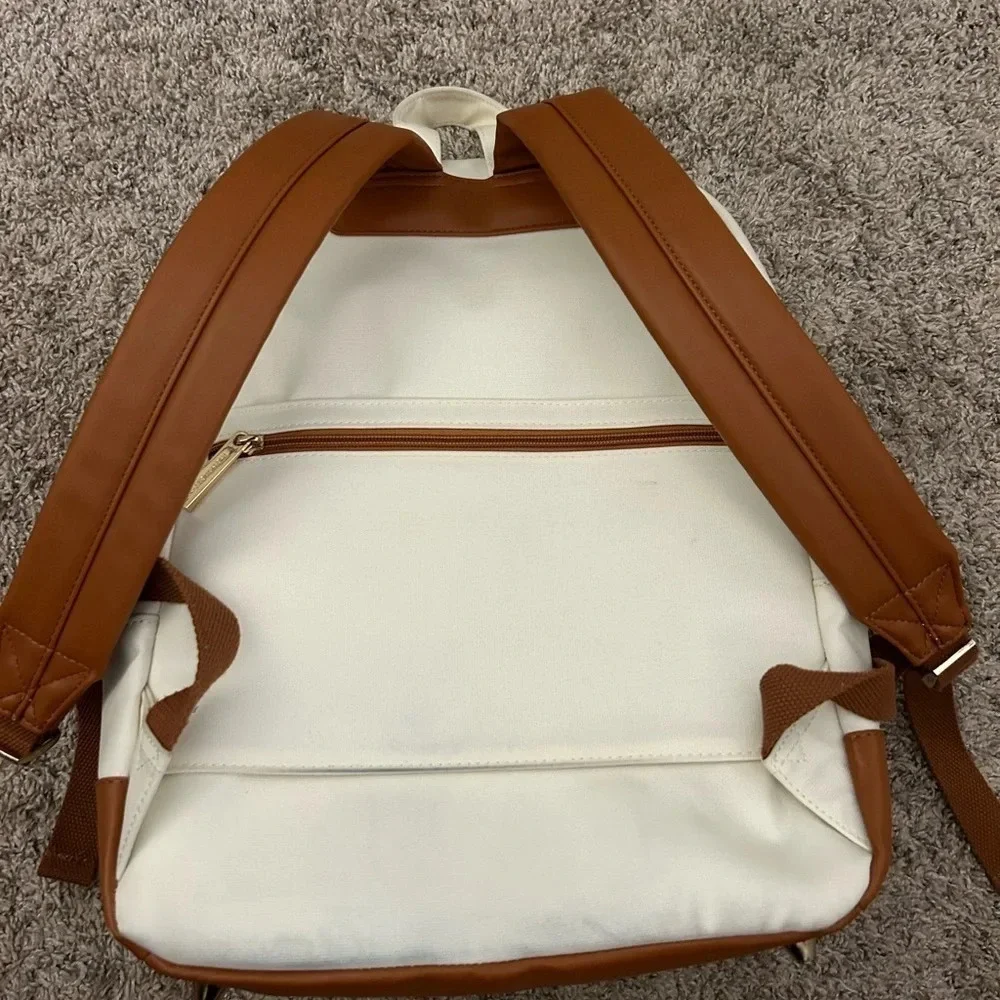 White and brown backpack